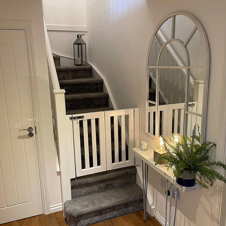 White stair gate at the bottom of a staircase