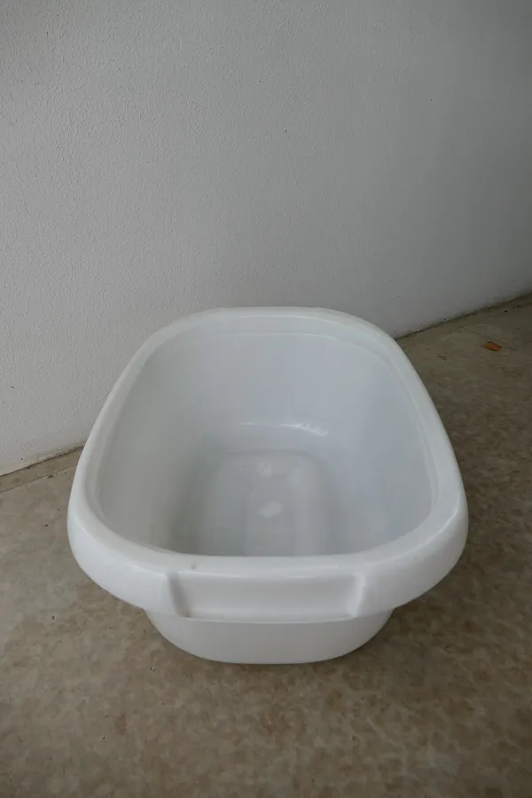 Plain white plastic baby bathtub