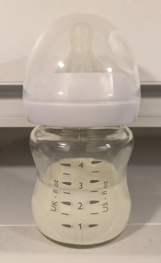 Clear plastic baby bottle with volume markings