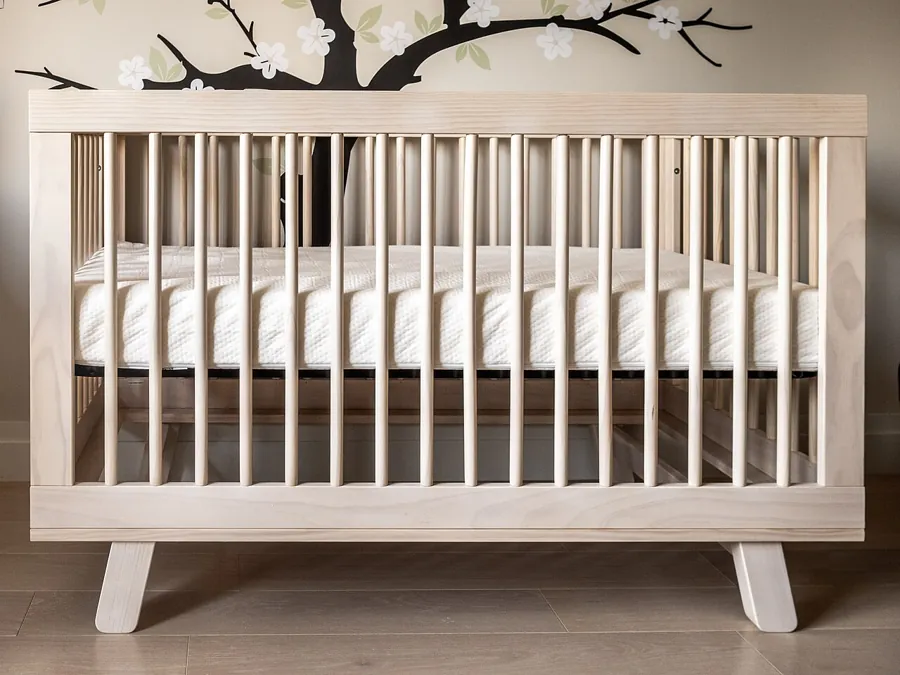 Natural wood crib with slatted sides