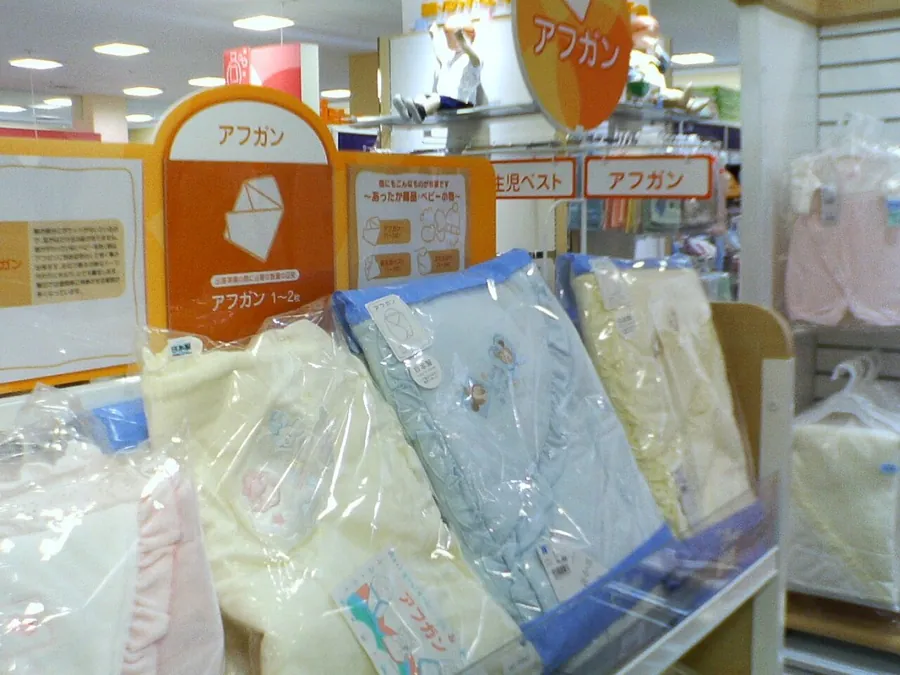 Swaddles and baby blankets on a store shelf